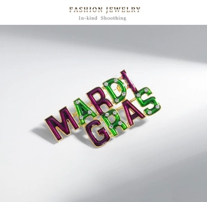 Detailed macro view of Mardi Gras brooch with purple green enamel and sparkling rhinestones