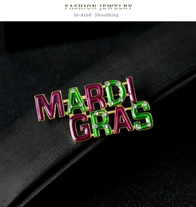 Detail of MARDI GRAS enamel brooch with purple green colors and sparkling rhinestones