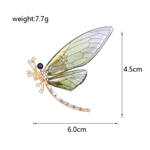 Colorful dragonfly brooch with crystal rhinestones and green wings on gold metal frame