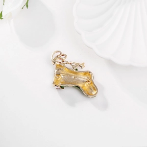 Golden Christmas stocking brooch back detail with secure horizontal pin on white background