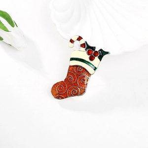 Detail of Christmas stocking brooch with glitter red enamel and gold spiral texture