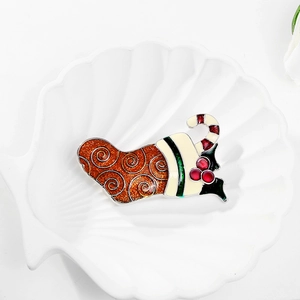 Christmas stocking brooch with red oil drip and candy cane detail on white shell tray
