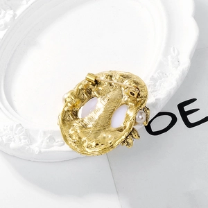 Baroque retro pearl brooch with secure clasp and gold-plated textured metal backing