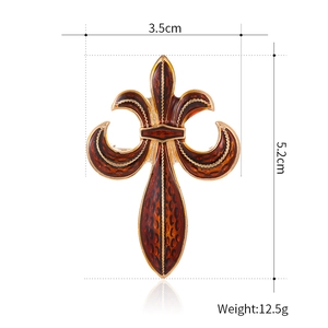 Vintage gold fleur-de-lis brooch with amber enamel and geometric honeycomb texture