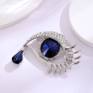 Broche créative en forme d'œil avec cristal bleu en goutte et strass scintillants