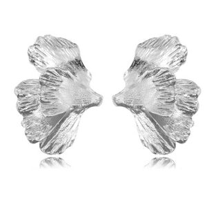 Detailed macro view of silver leaf-shaped earrings with matte brushed metallic texture
