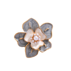 Vintage camellia flower brooch with blue enamel petals and elegant pearl center detail