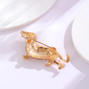 Golden dachshund brooch with matte metal finish shown from a detailed back view angle