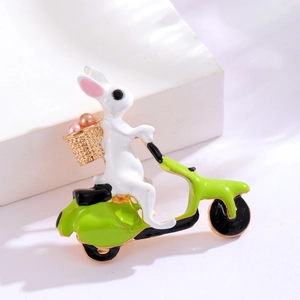 Cute enamel bunny riding a green scooter brooch with pearl accents in a gold-tone finish