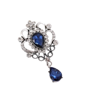 Vintage Baroque silver brooch with blue teardrop crystals and sparkling white rhinestones