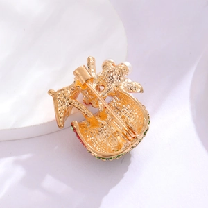 Back view of cute fruit brooch showing gold plating and secure safety pin buckle