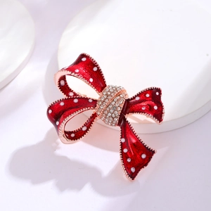 Elegant red polka dot bow brooch with crystal inlay and rose gold metallic finish