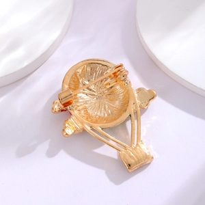 Golden hot air balloon brooch back view with secure pin and radial metal texture