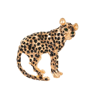 Broche léopard vintage dorée avec taches en émail noir et yeux en pierres vertes