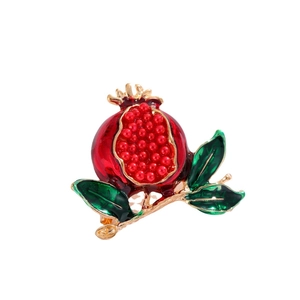Elegant enamel pomegranate brooch with red beads and green leaves on golden alloy branch