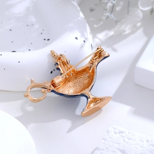 Vintage gold and blue enamel Aladdin lamp brooch showing the back pin mechanism