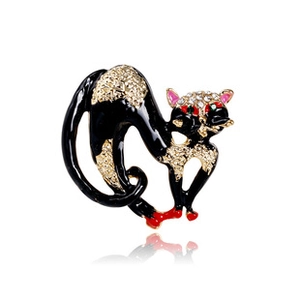 Detailed view of stretching black cat brooch with sparkling crystals and enamel finish