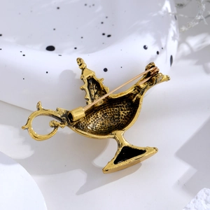 Detail view of the vintage gold magic lamp brooch back showing pin fastener
