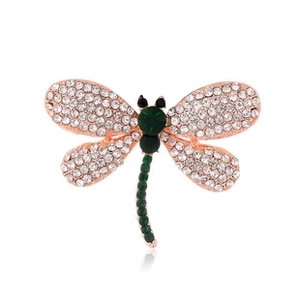 Detailed close-up of dragonfly brooch with rose gold frame and sparkling crystals