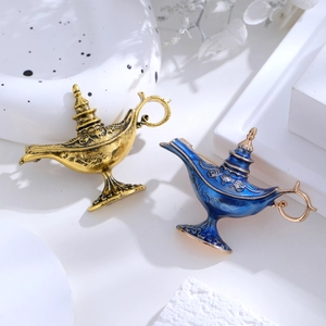 Vintage exotic Aladdin lamp brooches with detailed relief patterns on white background