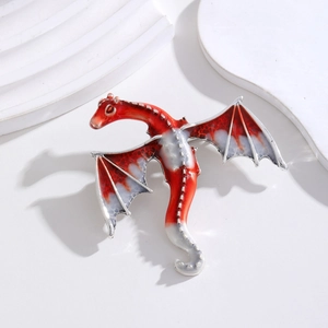 Close-up of red and white gradient dragon brooch with translucent enamel detailing