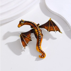 Detailed view of dragon brooch with amber resin inlay and intricate honeycomb texture