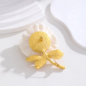 Back view of vintage cream floral brooch with gold base and secure pin fastener