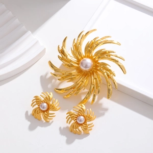 Detail of vintage gold spinning snowflake jewelry set with elegant pearl inlay