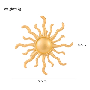 Artistic gold sunflower brooch for women and men featuring radiating wavy rays on white background