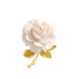 Elegant white resin rose brooch with gold leaf detailing on a clean white background