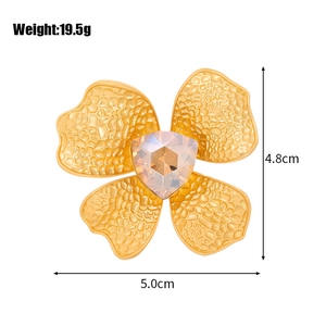Vintage style matte gold flower brooch with pink crystal and hammered metal texture