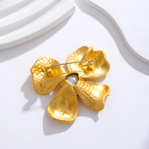 Vintage gold flower brooch with hammered metal texture and crystal detail on back view