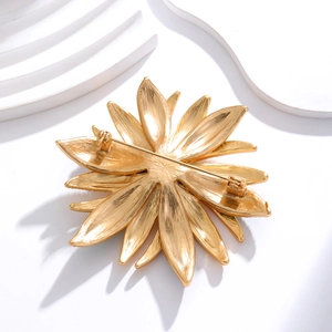 Back view of vintage gold flower brooch showing brushed metal texture and secure pin clasp