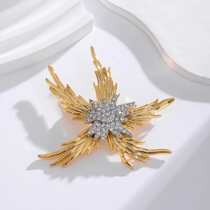 Luxurious gold and silver starfish brooch with sparkling crystals on minimalist background