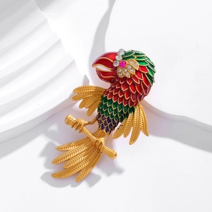 Tropical parrot brooch with colorful enamel and sparkling rhinestones on golden branch