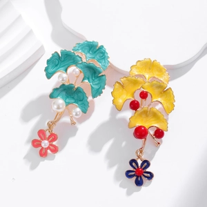 Elegant ginkgo leaf enamel brooches in green and yellow with pearl floral accents
