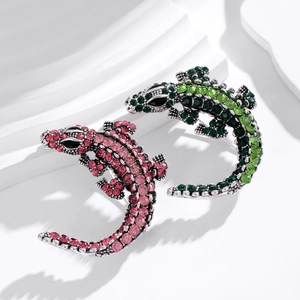 Detailed shot of vintage crocodile brooches with pink and green gradient rhinestones