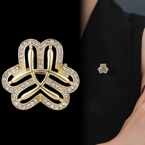 Elegant gold rhinestone brooch for women featuring interlocking design on suit lapel