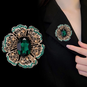 Vintage gold hollow flower brooch with emerald crystal and sparkling green rhinestones