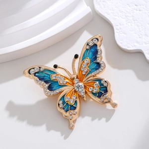 Eleganter Schmetterling-Brosche in Goldoptik mit blauem Emaille und glänzenden Strasssteinen