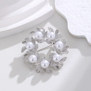 Minimalist silver wreath brooch with elegant leaf textures and seven white pearls on top