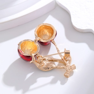 3D cherry brooch with red enamel and gold metal back view on white geometric background