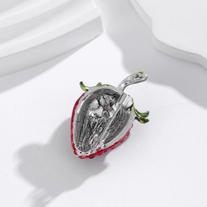 Detailed back view of strawberry brooch showing alloy structure and secure metal pin buckle