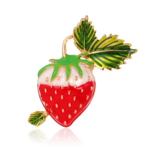 Macro shot of realistic strawberry brooch showing glossy red enamel and gold seeds