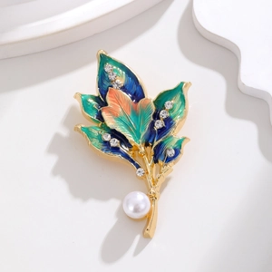 Elegant gold-plated leaf brooch with colorful enamel petals and a white pearl accent