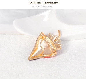 Close-up detail of the gold-plated alloy strawberry brooch back pin and safety clasp