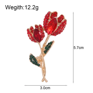 Elegant tulip flower brooch with red rhinestones and gold finish measuring 5.7cm by 3.0cm