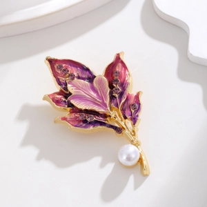 Detail of leaf brooch with purple enamel gradients, crystals and a white pearl accent