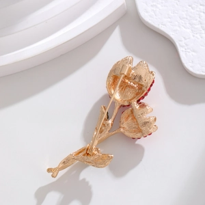 Elegant gold tulip brooch with red rhinestones shown from the back showing pin clasp