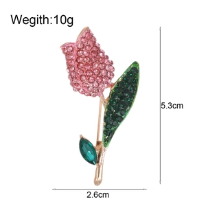 Exquisite tulip flower brooch featuring pink crystals and gold finish on white background